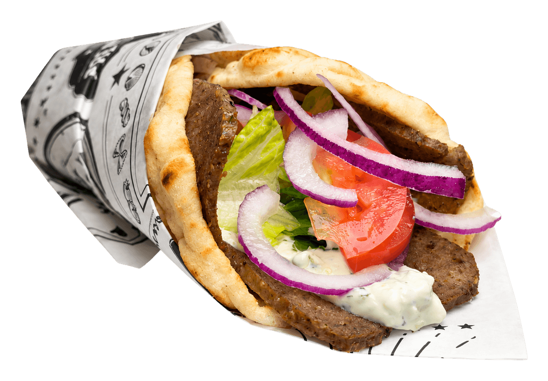 Pita wrap with sliced gyro meat, lettuce, tomato, red onion and white sauce in printed paper.