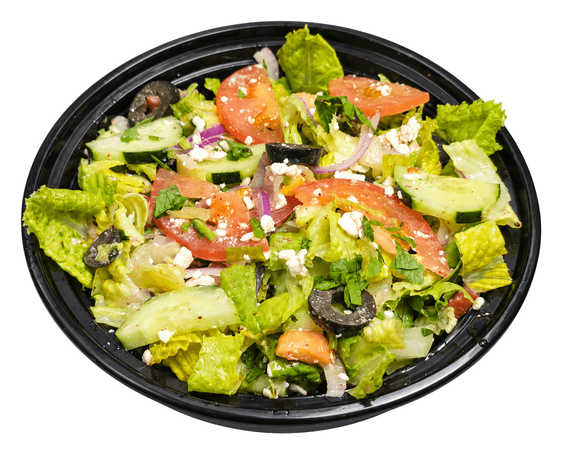 Black bowl of Mediterranean salad with lettuce, tomato, cucumber, olives and feta.